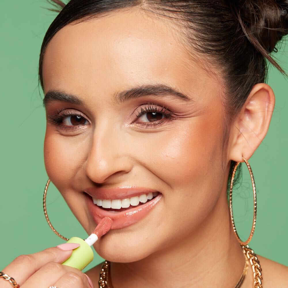 Close-up of a model’s face as she applies NYX Fat Oil Lip Drip, showcasing how to keep lips moisturised