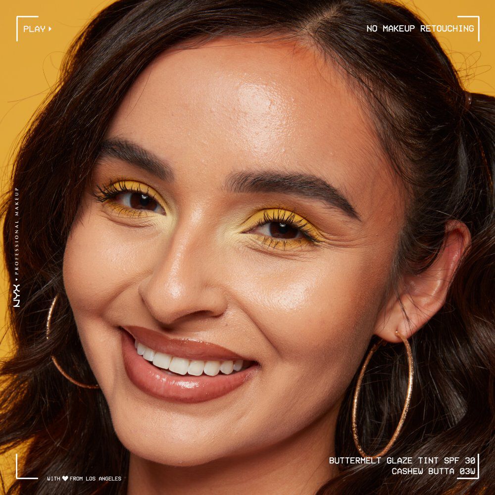 A woman with makeup on outdoors in the sun