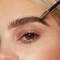 Close-up of a model’s face showcasing how to use brow gel