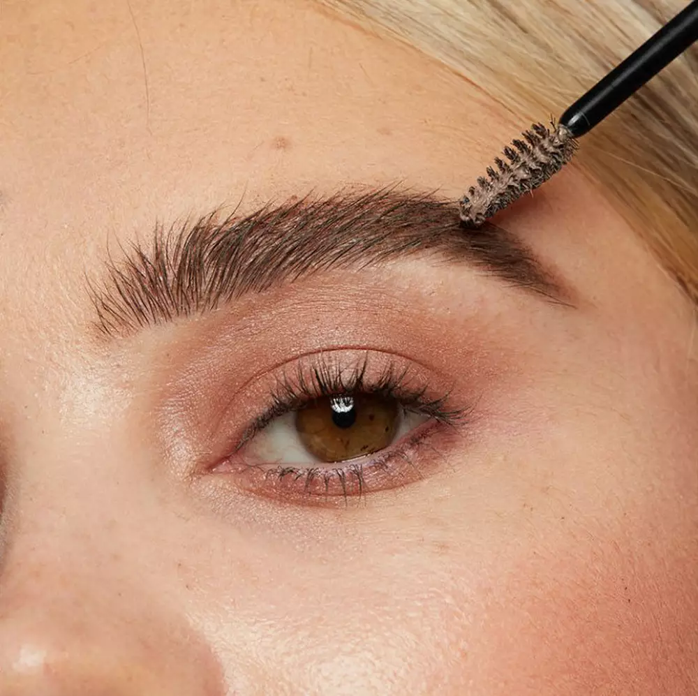 Close-up of a model’s face showcasing how to use brow gel