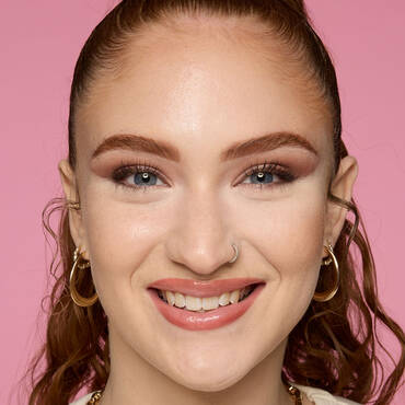 NYX model with flawless makeup showing how to use setting powder