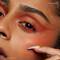 A close-up shot of a young woman wearing NYX’s Epic Smoke Liner in the Fired-Up shade.